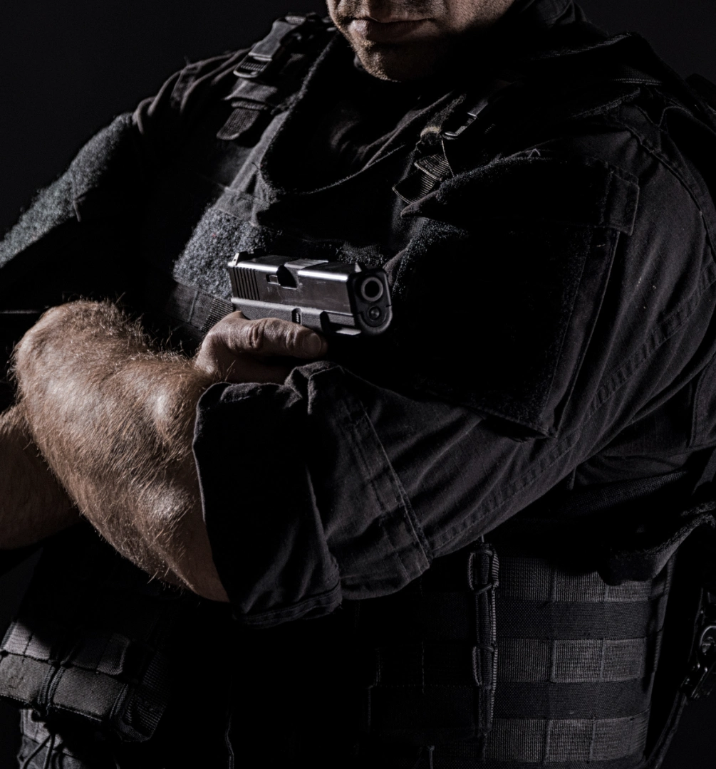 Armed security personnel in dark uniform
