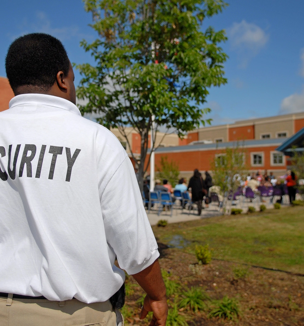 Guard monitoring outdoor gathering scene