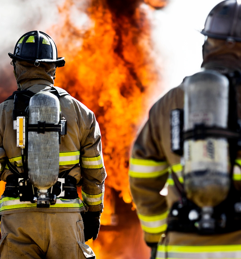 Two firefighters confronting a large fire