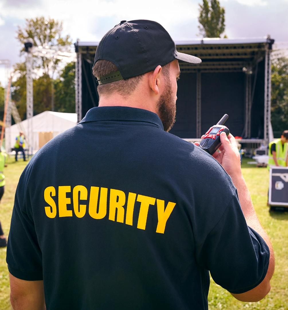 Security officer overseeing outdoor stage setup