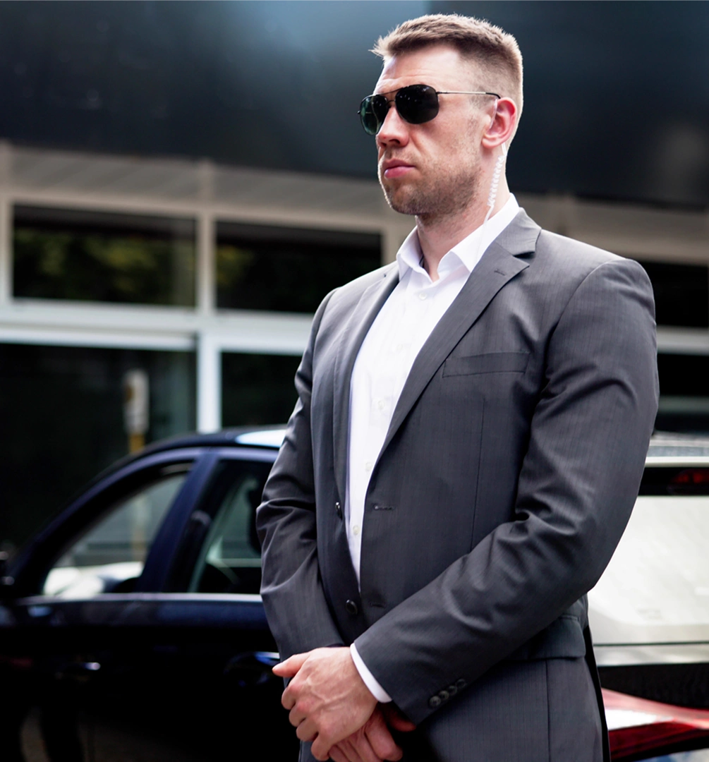 Confident man standing by car