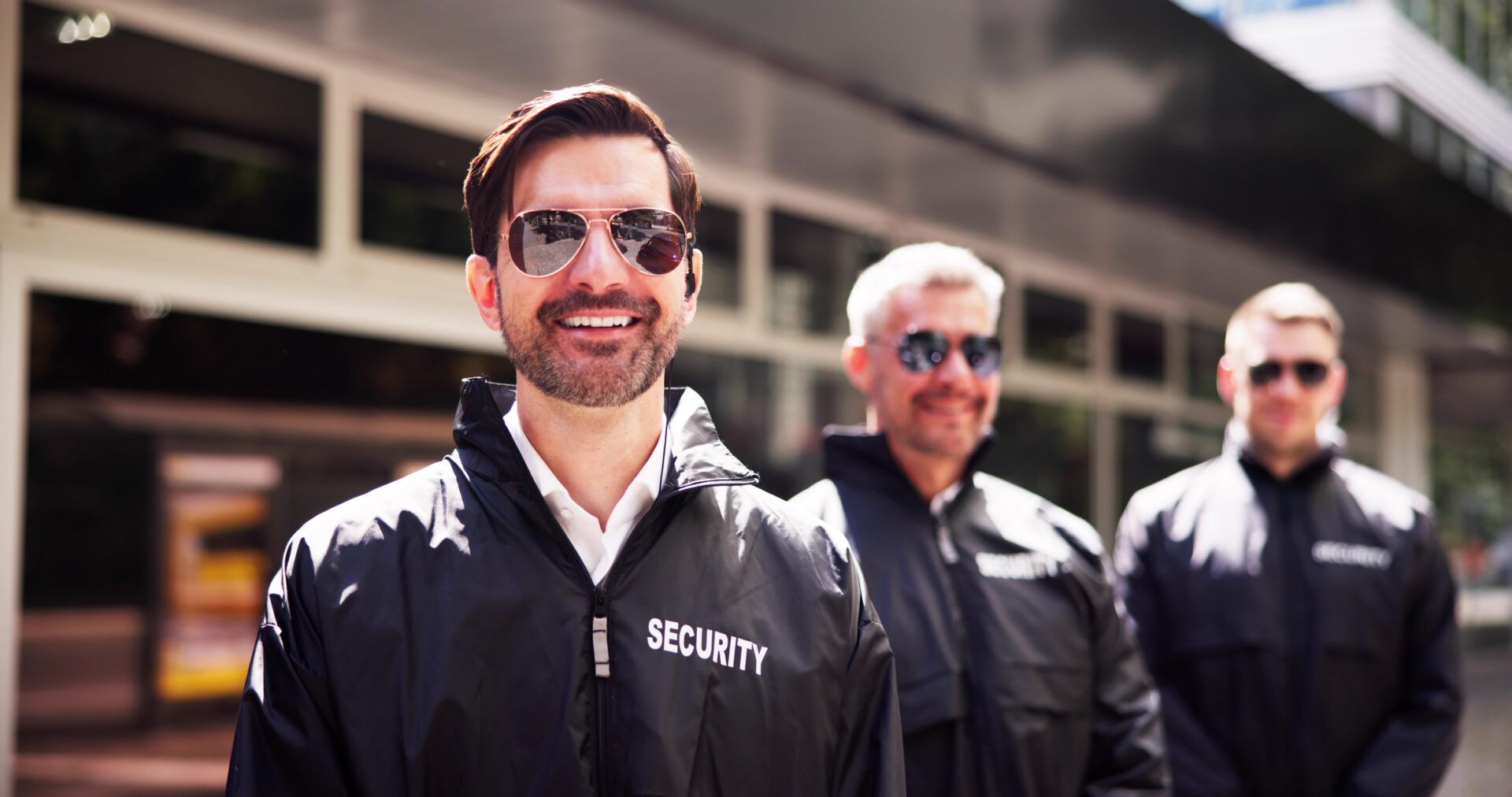 Group of smiling security personnel outside