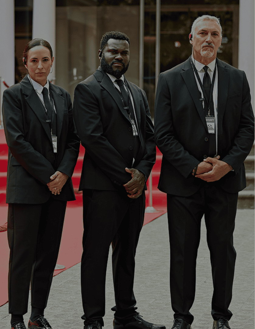 Three security guards in formal suits.