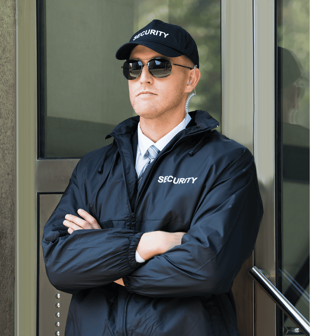 Security guard standing with arms crossed.