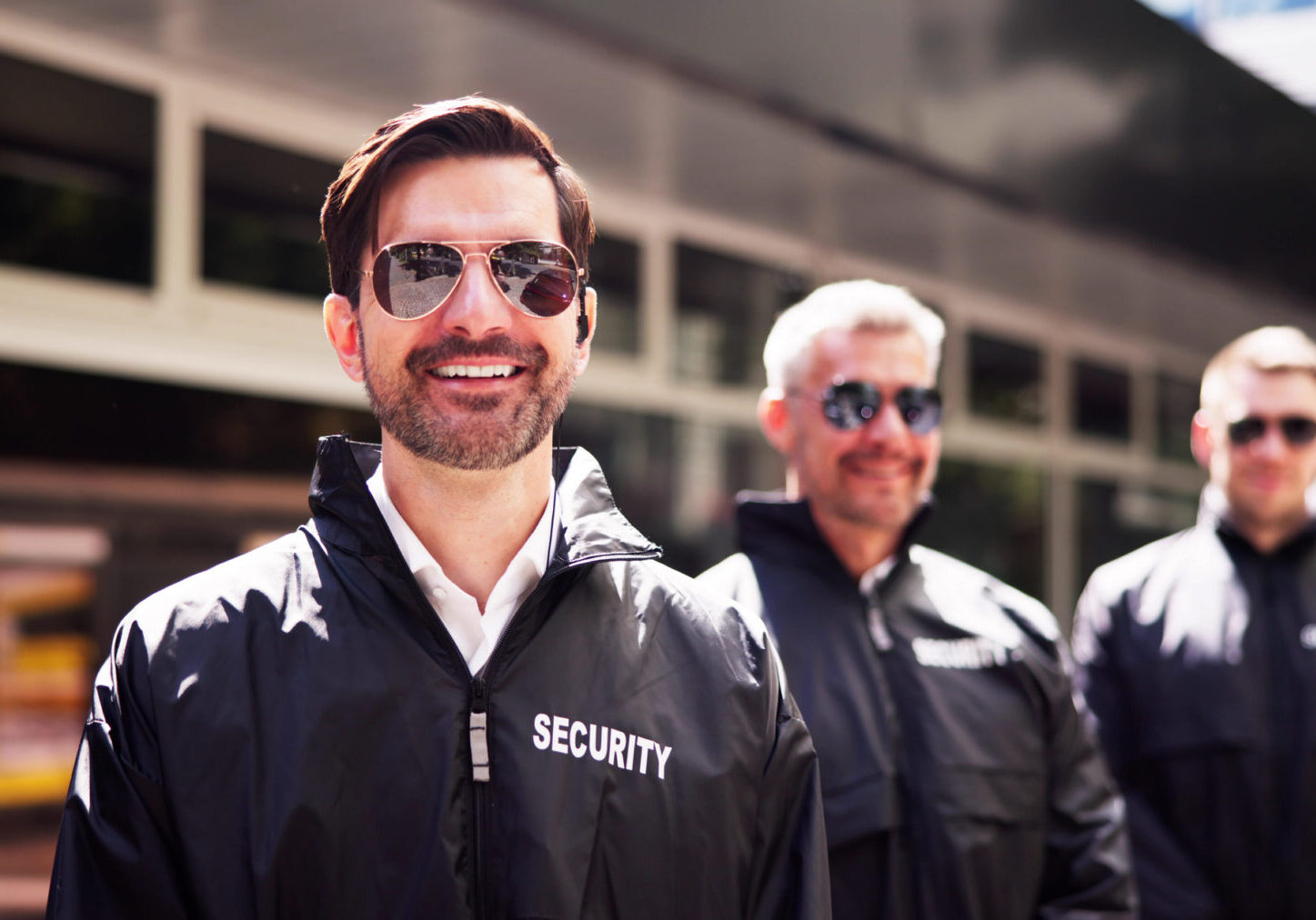 Group of smiling security personnel outside
